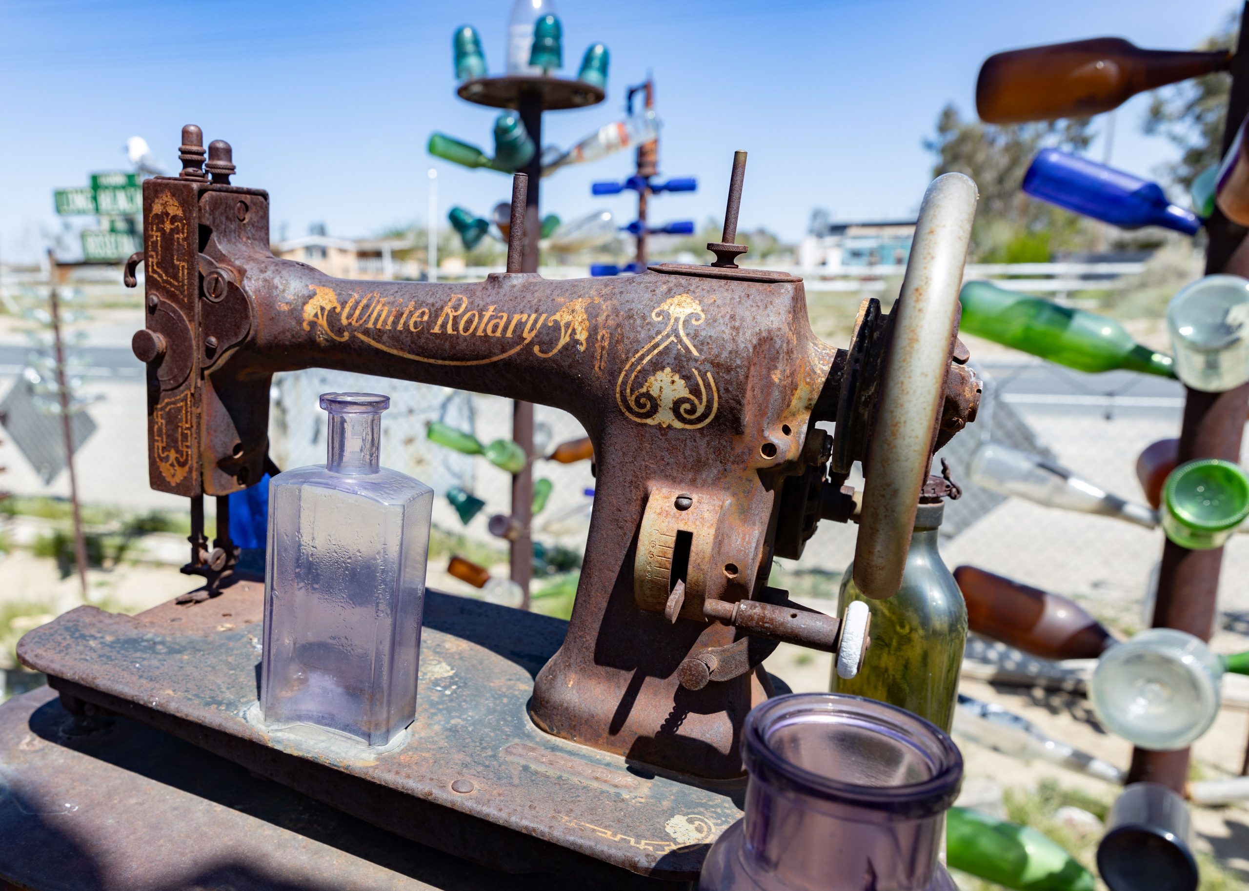 1M3A5953 - Bruce Herwig An old sewing machine surrounded by colorful glass bottles.