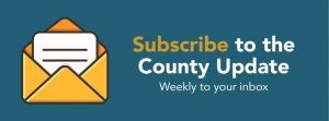 A teal bos with an open envelope graphic icon on the left with the words Subscribe to the County Update Weekly to your inbox.