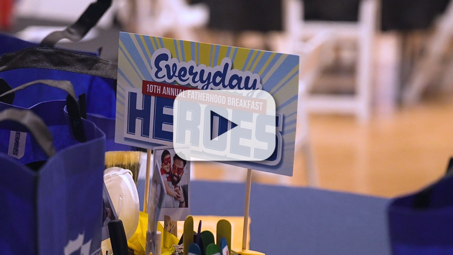 A video thumbnail of the breakfast with a table and a centerpiece that says everyday heroes.