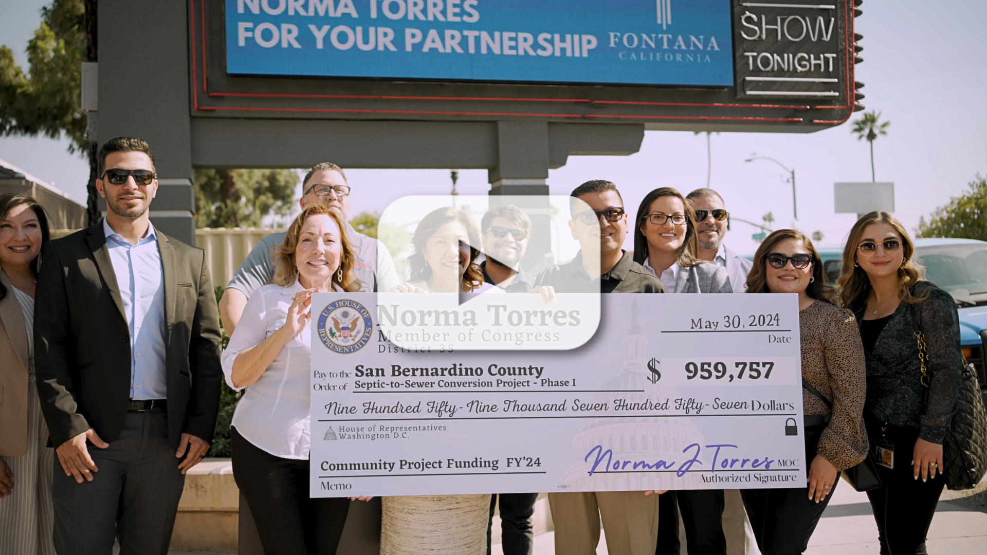 A group of elected officials from Fontana, San Bernardino County and Congressmember Norma Torres holding a large check for $959,757.