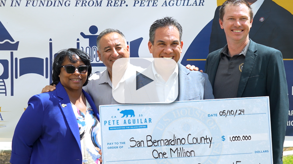 A photo of the Director of Regional Parks Beahta Davis, Fifth District Supervisor Joe Baca, Jr., Congressmember Pete Aguilar and Deputy Executive Officer Trevor Leja standing in front of a large sign at Glen Helen Regional Park holding a giant check made out to San Bernardino County in the amount of $1 million.