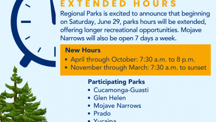 A graphic of a illustration of a blue sky with white clouds and trees and rolling hills with a pond and bird in the sky at top. A graphic of half of a wind up alarm clock is seen next to words advertising the extended hours at Regional Parks in bold, chunky font.