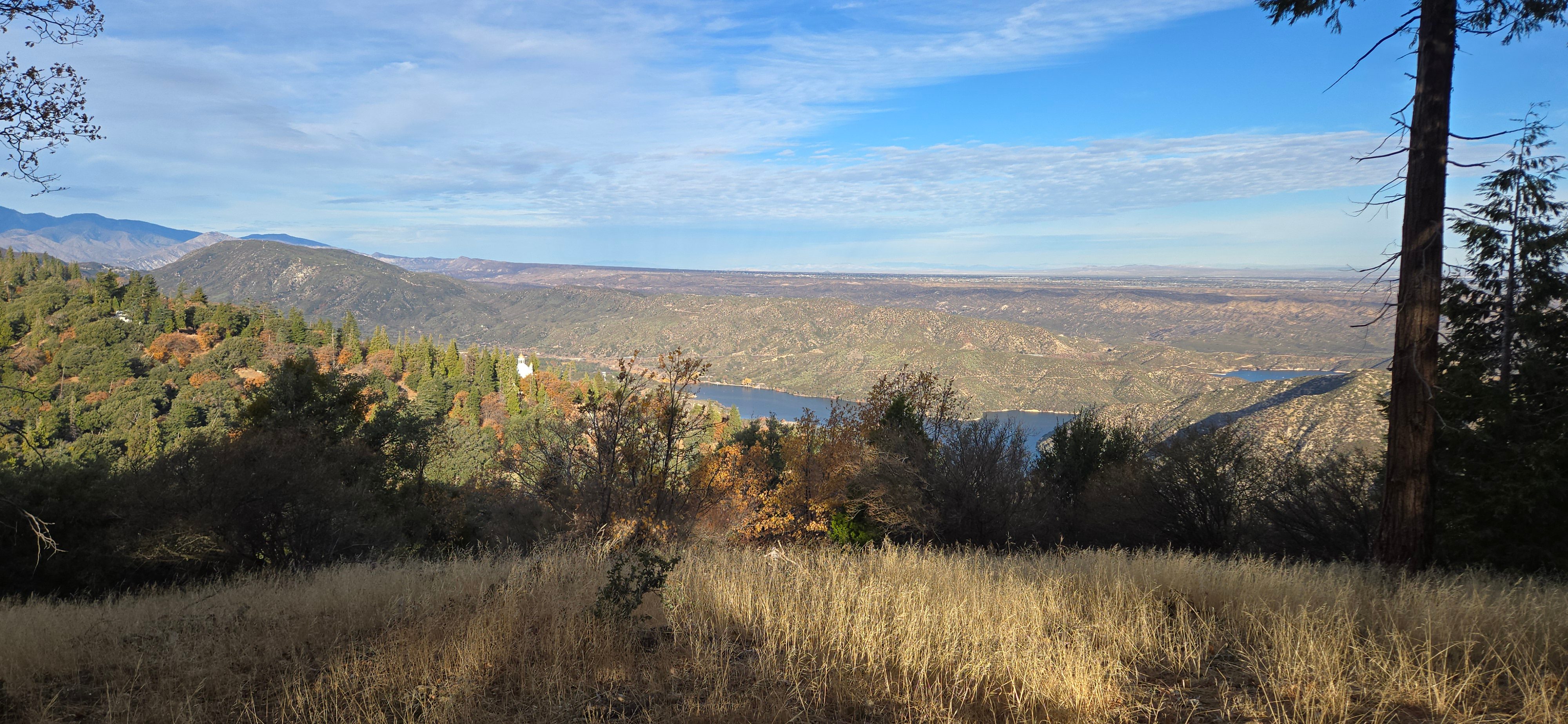 A view of the mountains with a lake in the background.