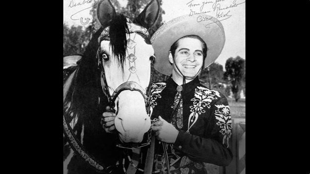 Picture of a cowboy holding on to his horse.