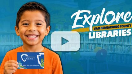Smiling boy holds San Bernardino County Library Card with text “Explore San Bernardino County Libraries” and video play button overlay.