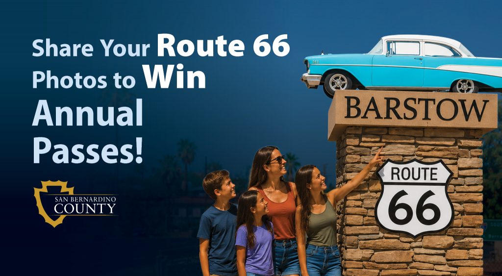 A group of people looking at a classic car on a stone structure labeled "Barstow" with a "Route 66" sign. Text reads: โShare Your Route 66 Photos to Win Annual Passes!โ The San Bernardino County logo is visible.