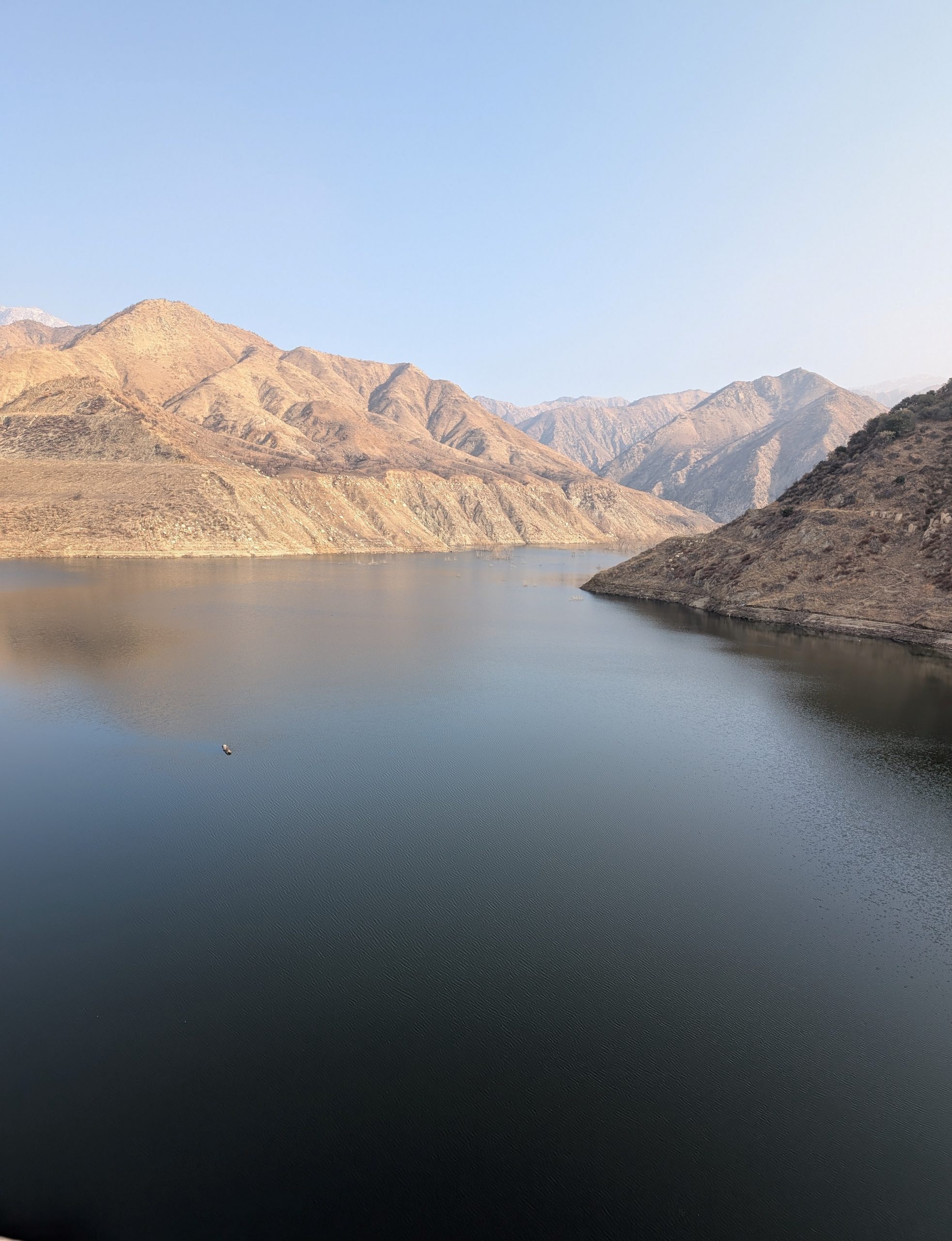 A dam surrounded by mountains.