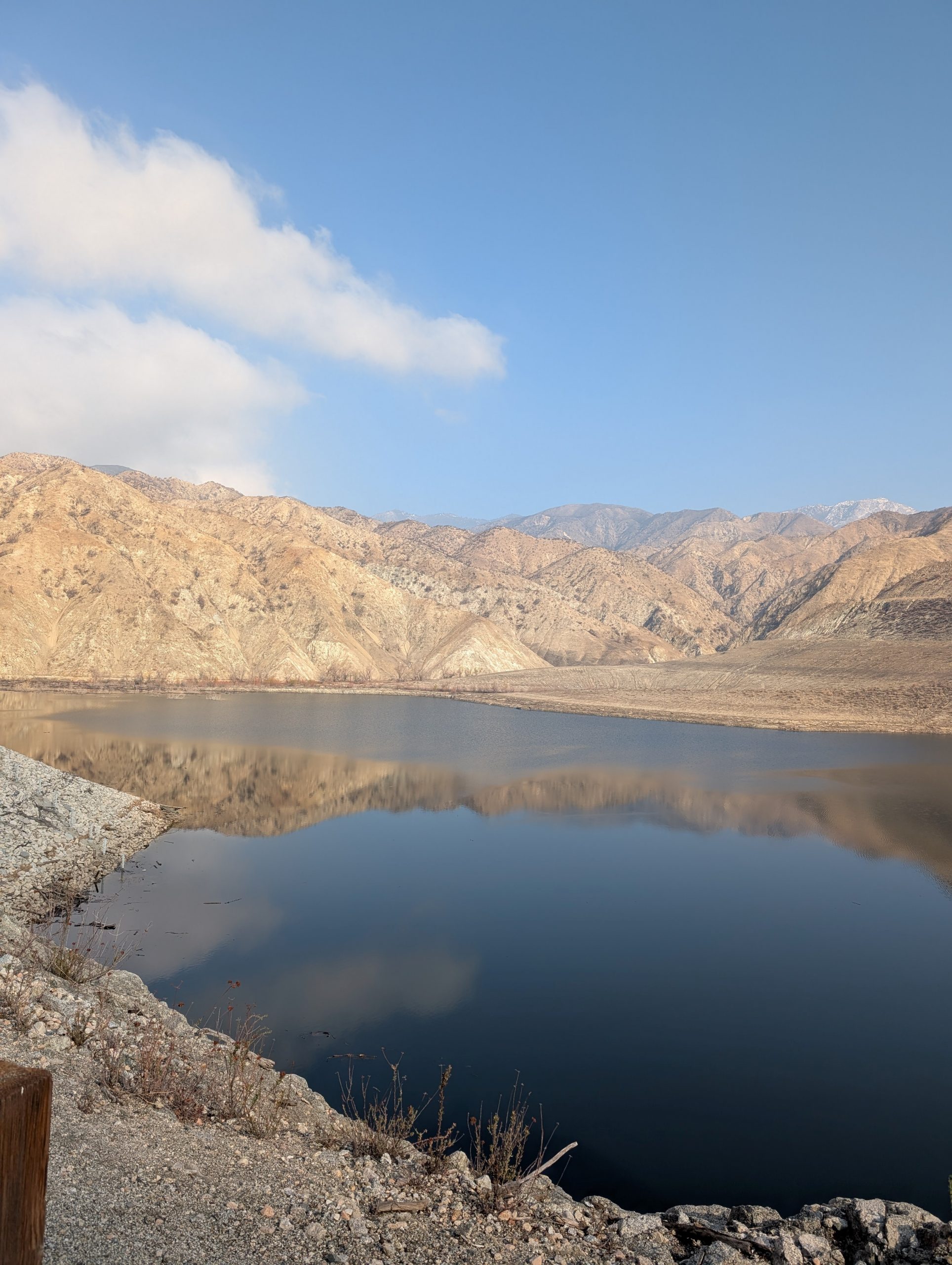 A view of a dam surrounded by mountains.