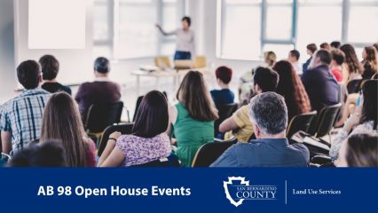 Attendees listen to a presenter during an AB 98 Open House event hosted by San Bernardino County Land Use Services.