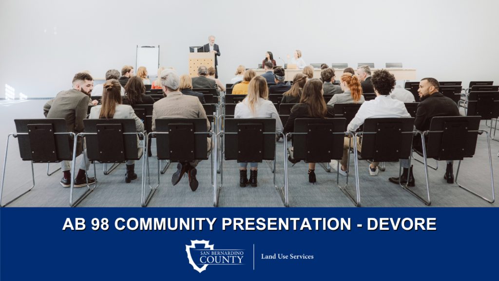 A speaker addresses a seated audience. Text: “AB 98 Community Presentation – Devore" and San Bernardino County Land Use Services logo.
