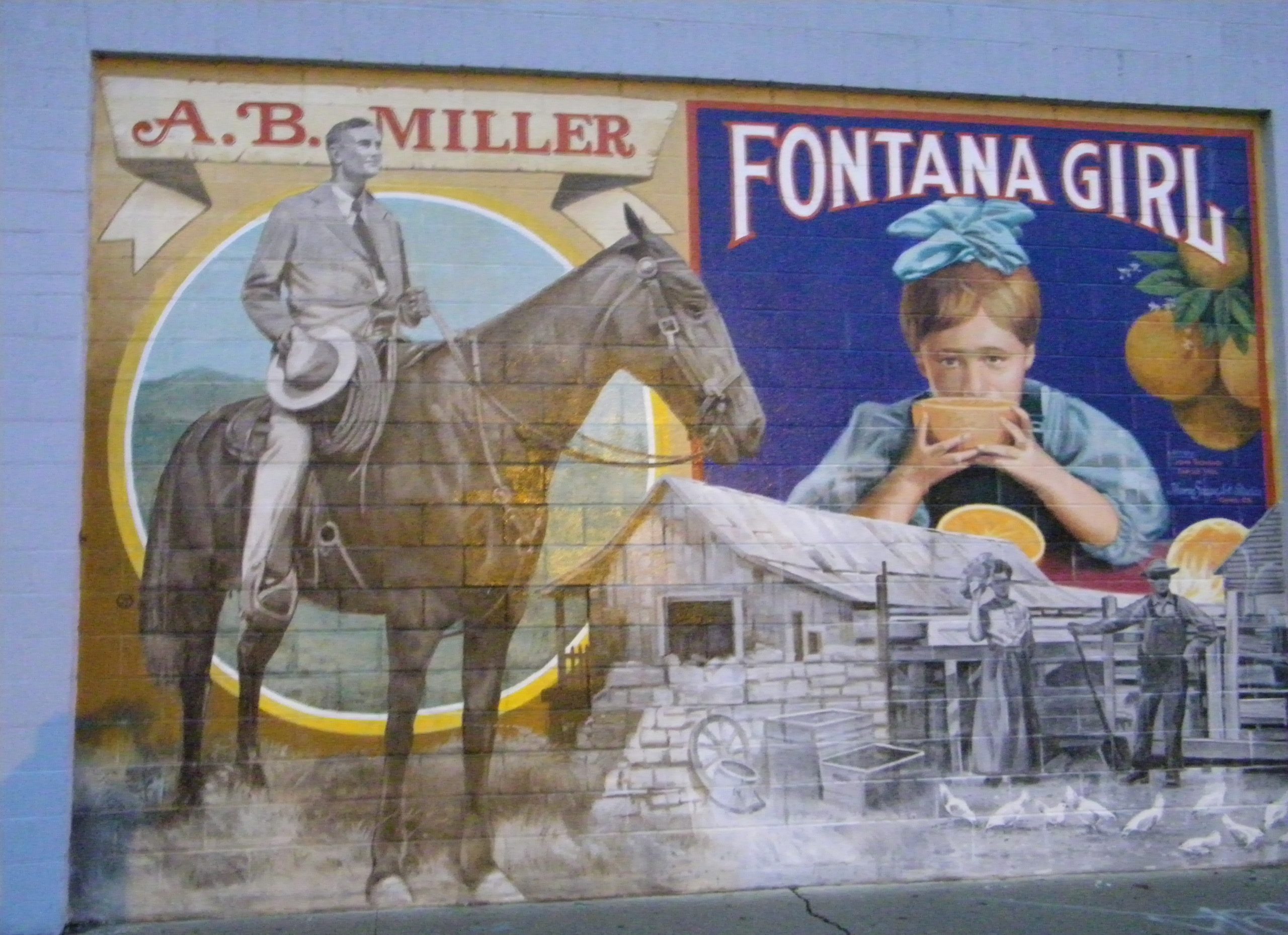 A mural depicting historical scenes, including a person named A.B. Miller on a horse, and a child drinking juice from an orange with text that says “Fontana Girl” above her. The artwork also features an old mill and workers in a field.