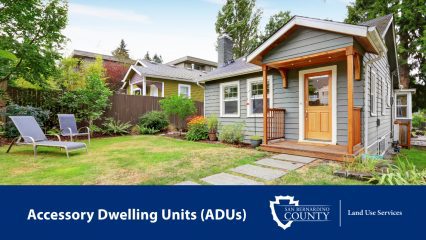A small gray house with a porch and two lawn chairs. Text “Accessory Dwelling Units (ADUs)” with the San Bernardino County Land Use Services logo.