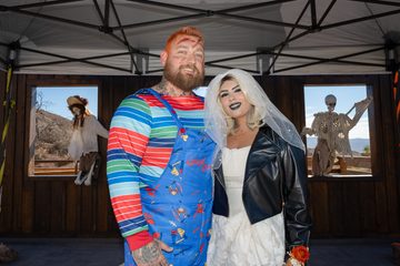 Bride and groom dressed as Chucky and Tiffany Valentine pose together during their wedding at Calico Ghost Town.