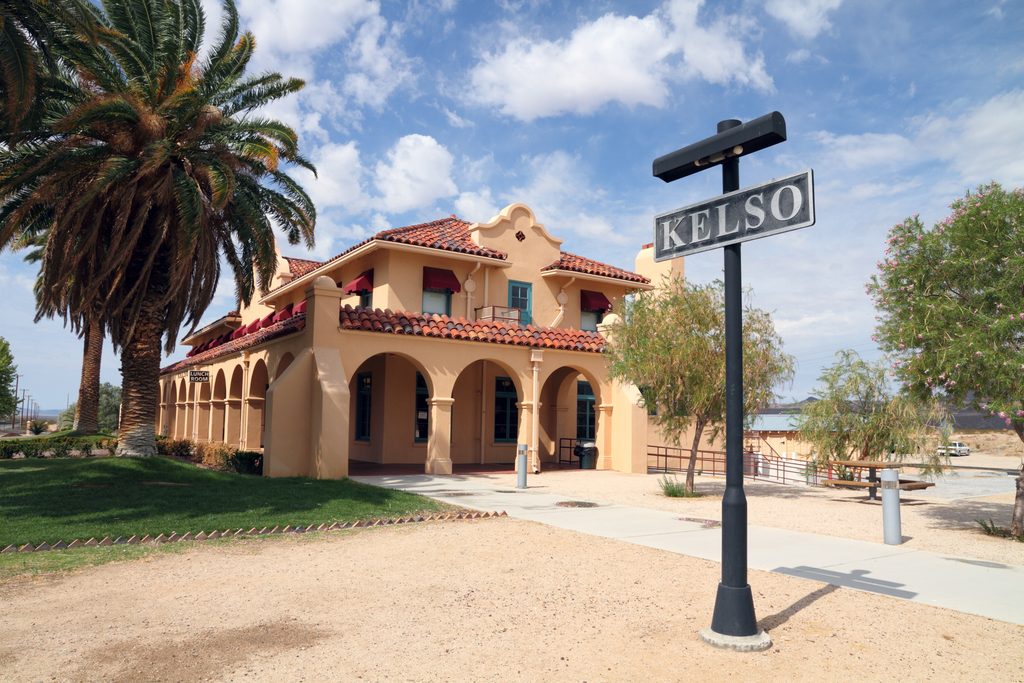 A historic building surrounded by several trees. A sign in the foreground reads "Kelso."