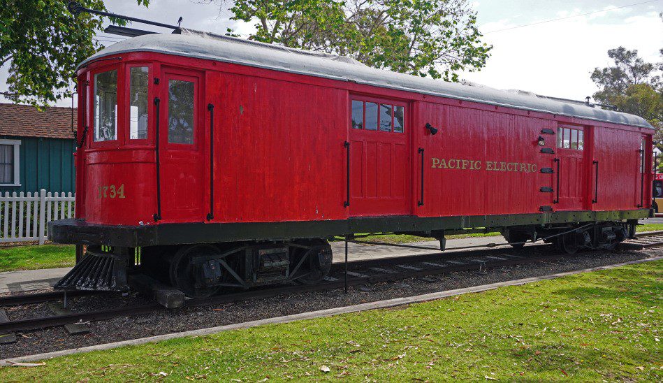 A red Pacific Electric Railway car on train tracks.