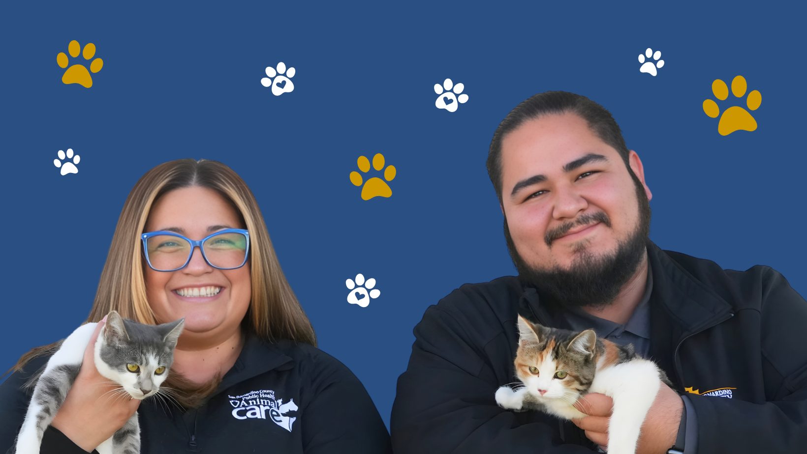 Two smiling animal care staff hold kittens against a blue background with paw prints, promoting pet adoption.