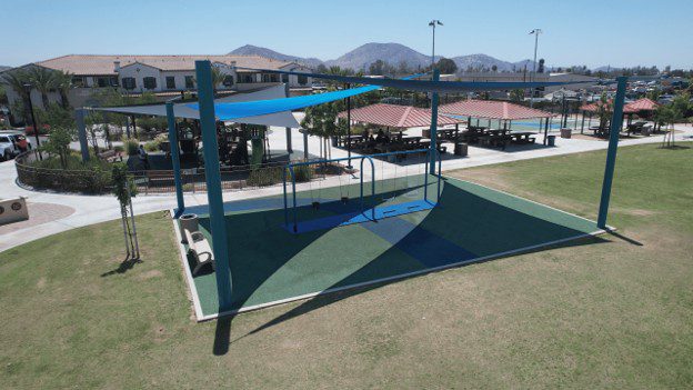 Aerial photo looking at new swing set and canopy at community center.