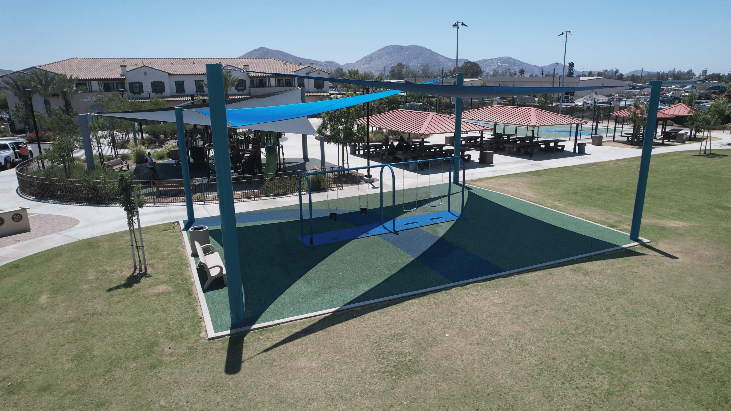 Aerial photo looking at new swing set and canopy at community center.