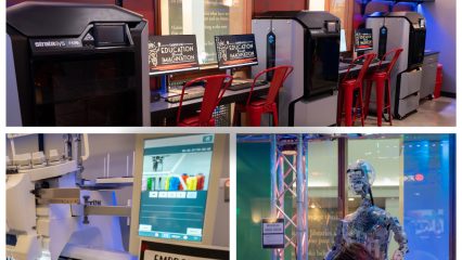 A vibrant makerspace featuring 3D printers, an embroidery machine, and a humanoid robot. Red chairs add a lively touch, conveying creativity and innovation.