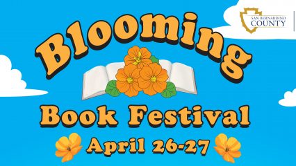 A promotional image promoting the Blooming Book Festival at County Library branches, featuring blooming flowers, a picnic setting and children engaging in reading. Festival focused on literary awareness during April 26-27 with the opportunity to earn an awesome prize.