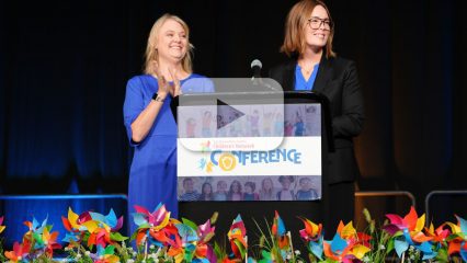 Two women stand at a podium during the San Bernardino County Children’s Network Conference.