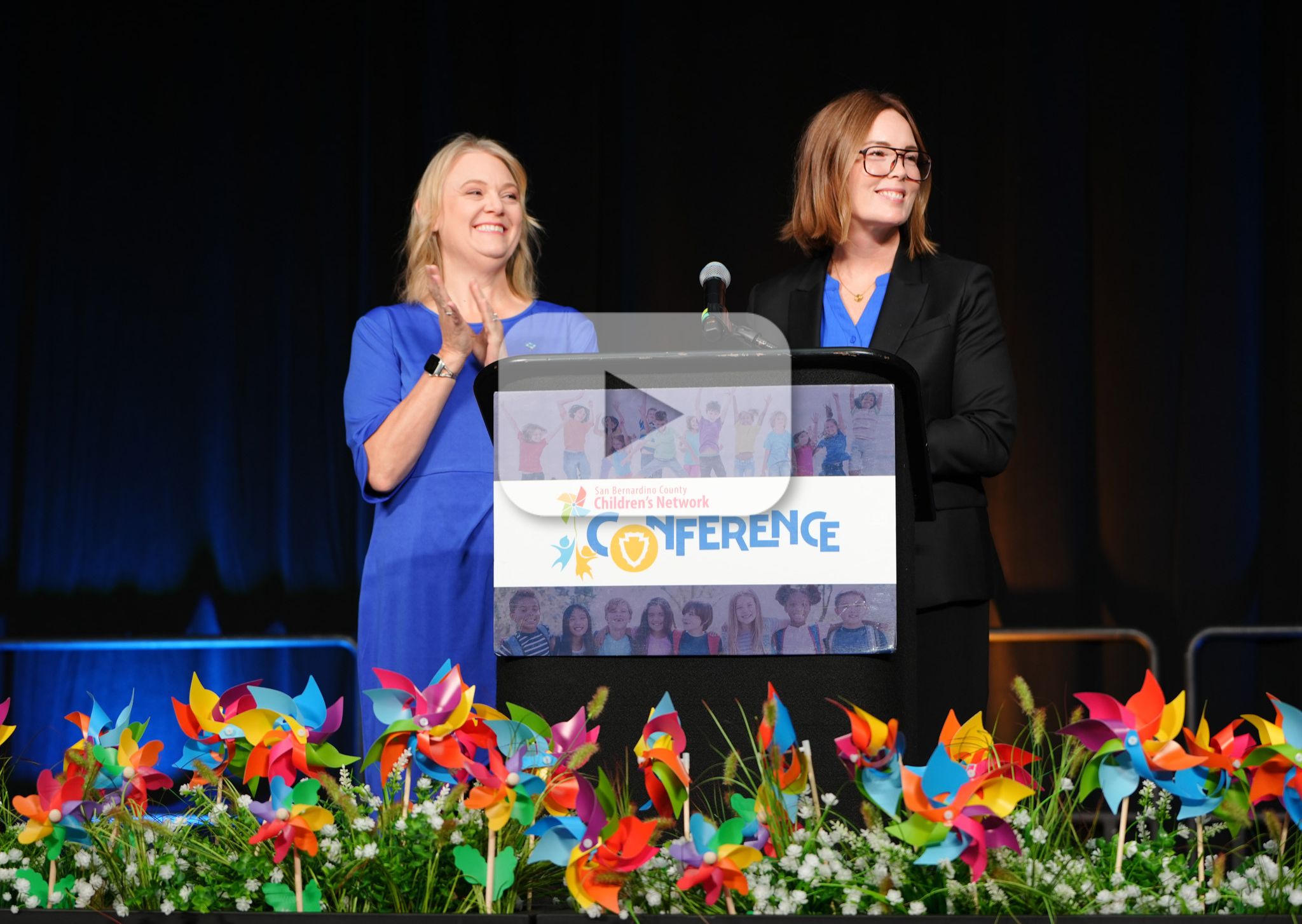 Two women stand at a podium during the San Bernardino County Children’s Network Conference.