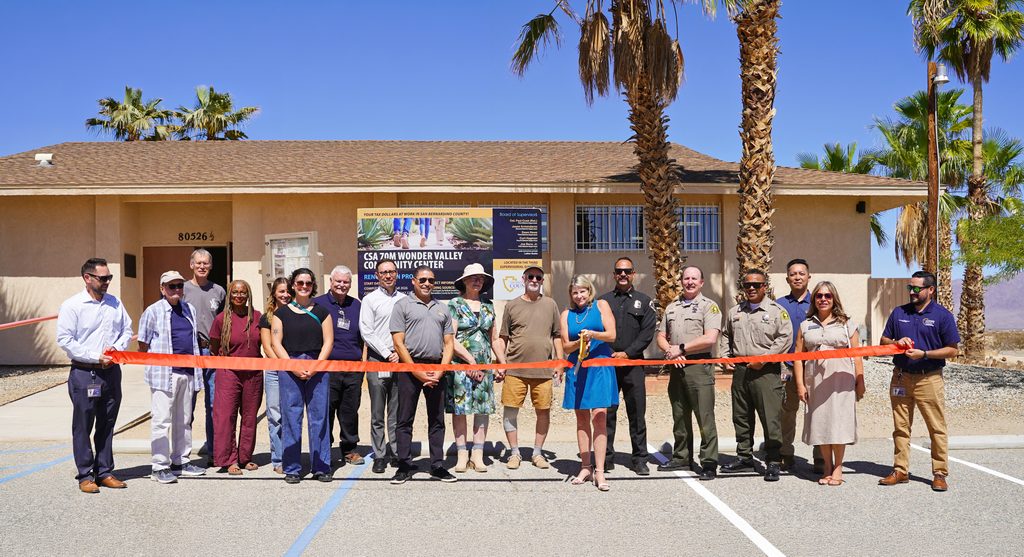 County leaders and community members gather for a ribbon cutting outside the Wonder Valley Community Center.