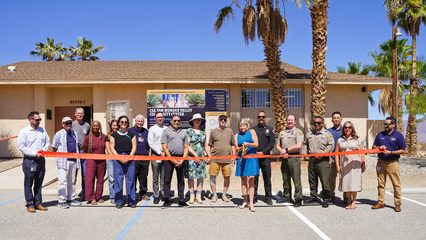 County leaders and community members gather for a ribbon cutting outside the Wonder Valley Community Center.