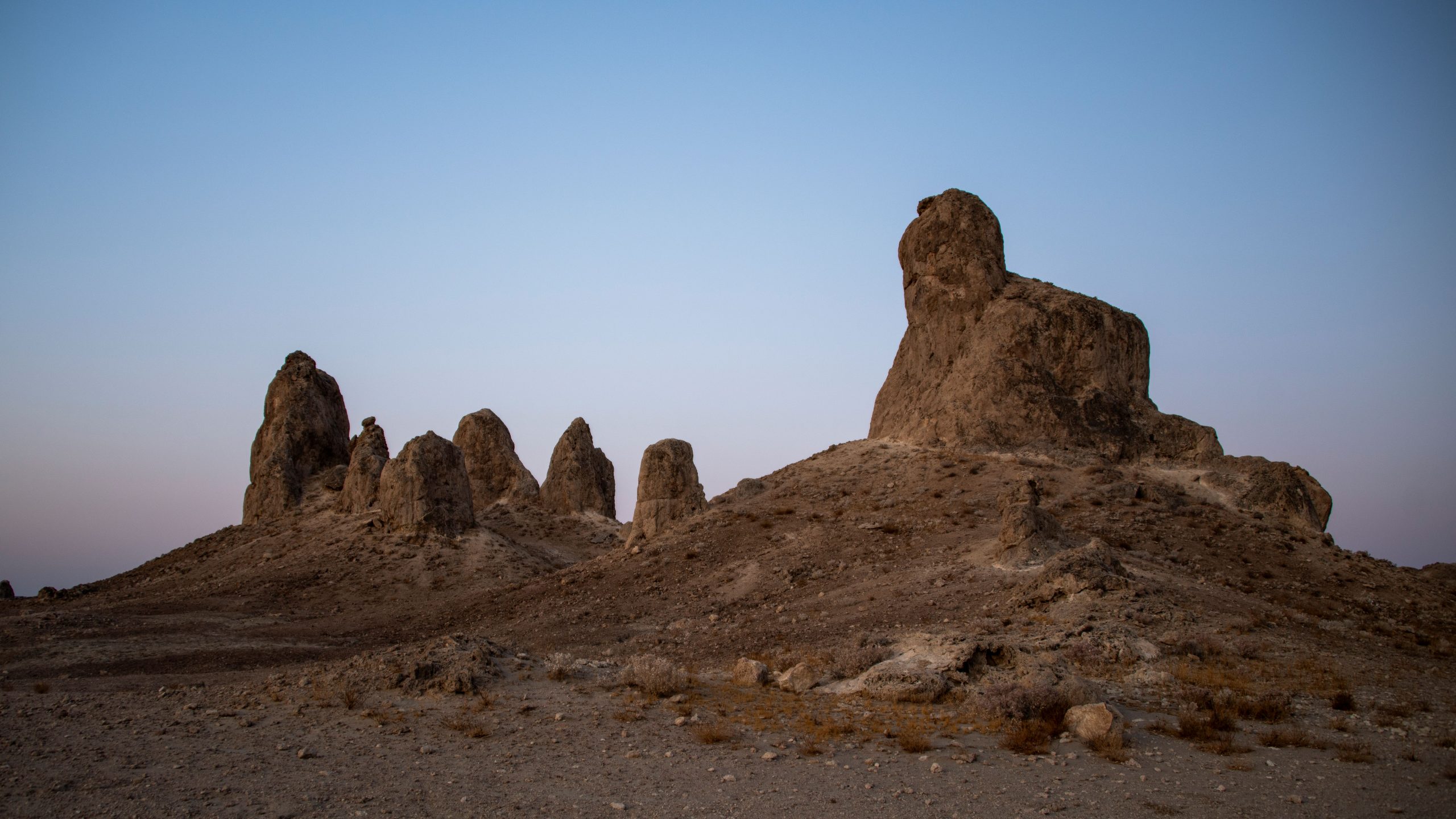 Sunset view of the Trona Pinnacles, featuring distinctive rock formations in a desert landscape.