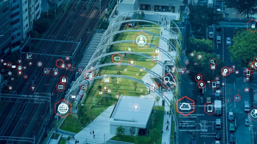 People in an urban park with digital map icons overlaid to represent data, technology and GIS tools.