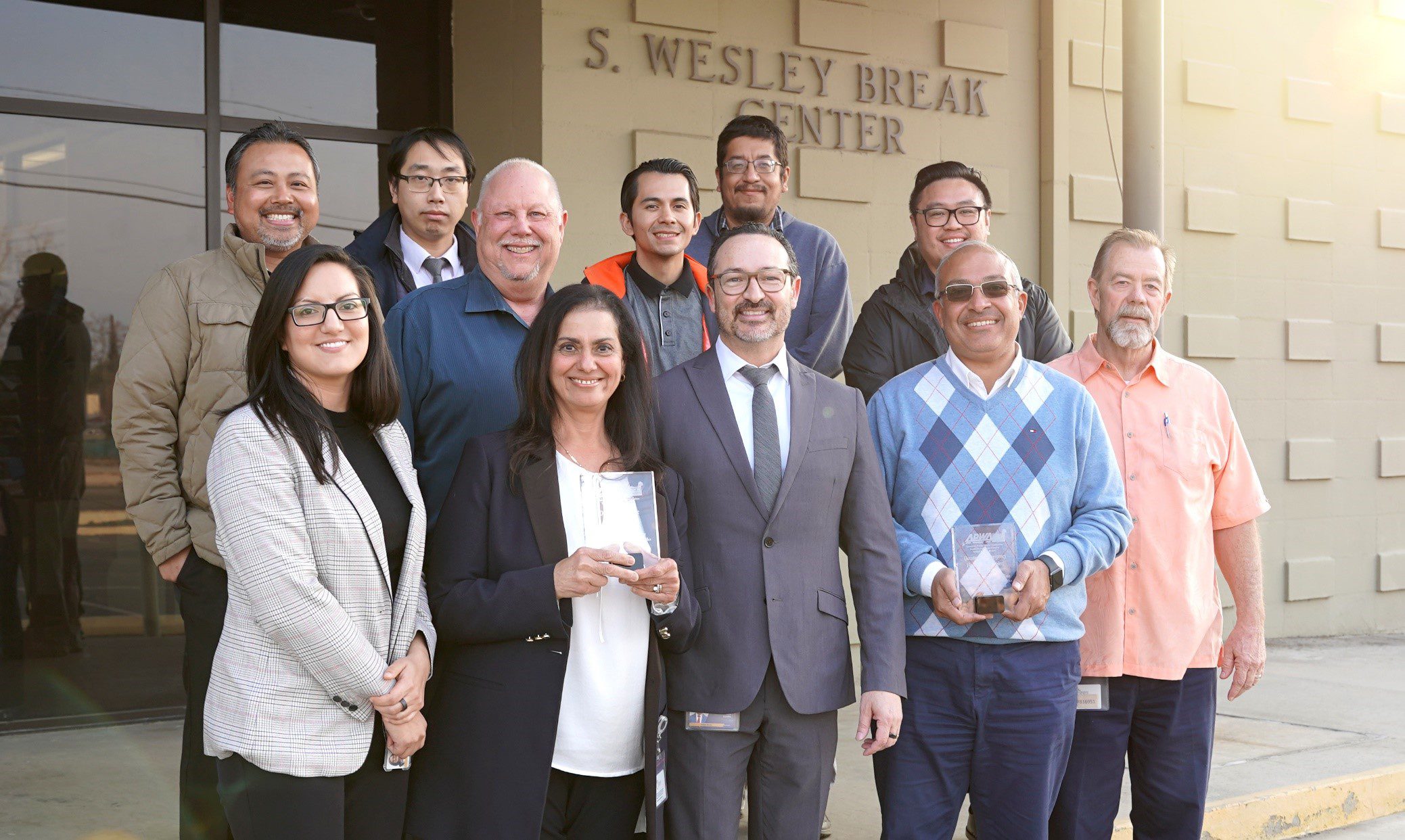 Public Works team members proudly display their APWA awards for the High-Intensity Activated Crosswalk (HAWK) Beacon System and Oak Glen Road at Birch Creek Culvert Replacement.