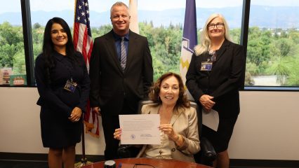 Four County staff pose as Assessor-Recorder-County Clerk Josie Gonzales holds supplemental roll #140.