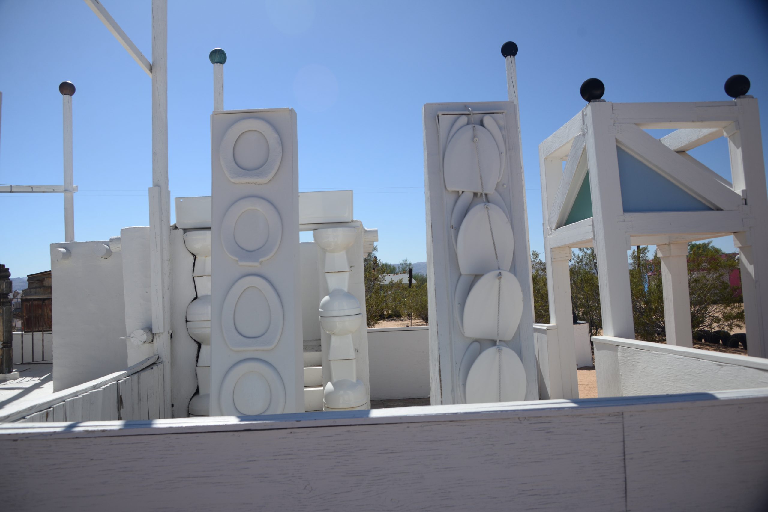 View of the Noah Purifoy's Outdoor Desert Art Museum exhibit featuring sculptures made from toilet bowl pieces.
