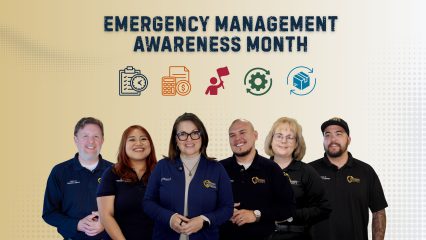 Six individuals are in front of a banner that reads "Emergency Management Awareness Month.” Emergency preparedness icons, including a flashlight, first aid kit and emergency supplies, appear in the banner.