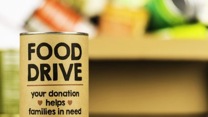 An image of a can with text: Food drive – your donation helps families in need.