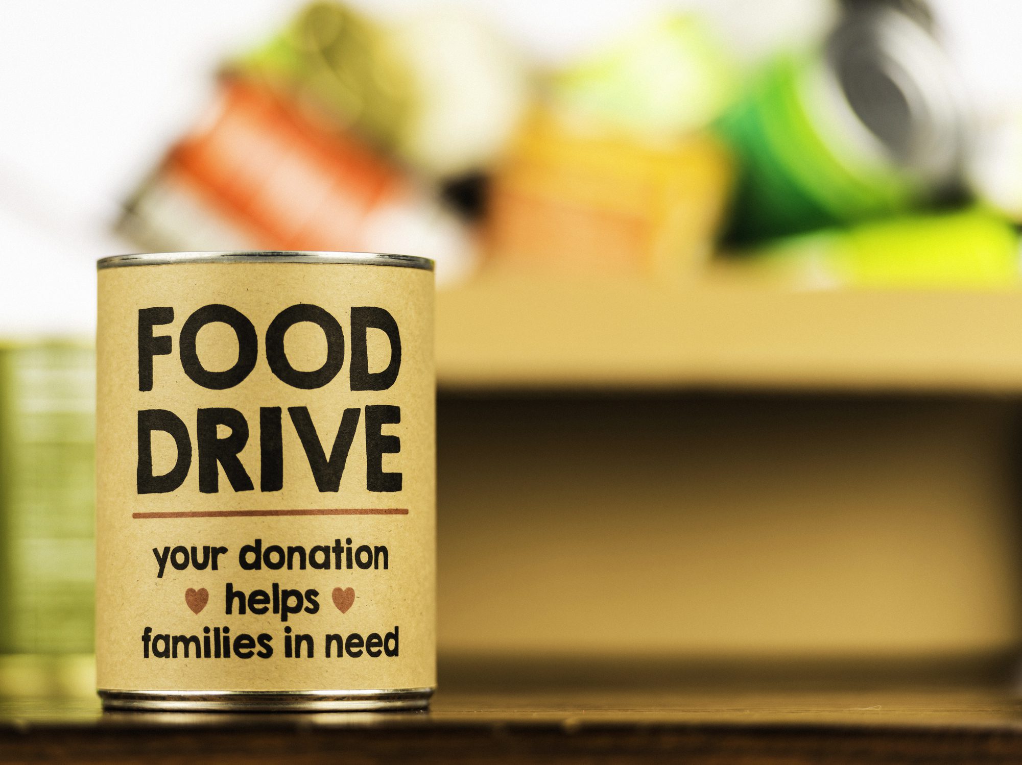 An image of a can with text: Food drive – your donation helps families in need.