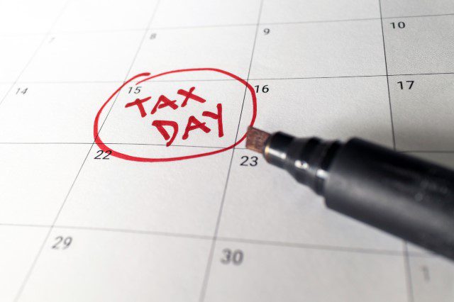 Image of a calendar with the date of April 15 Tax Day circled.