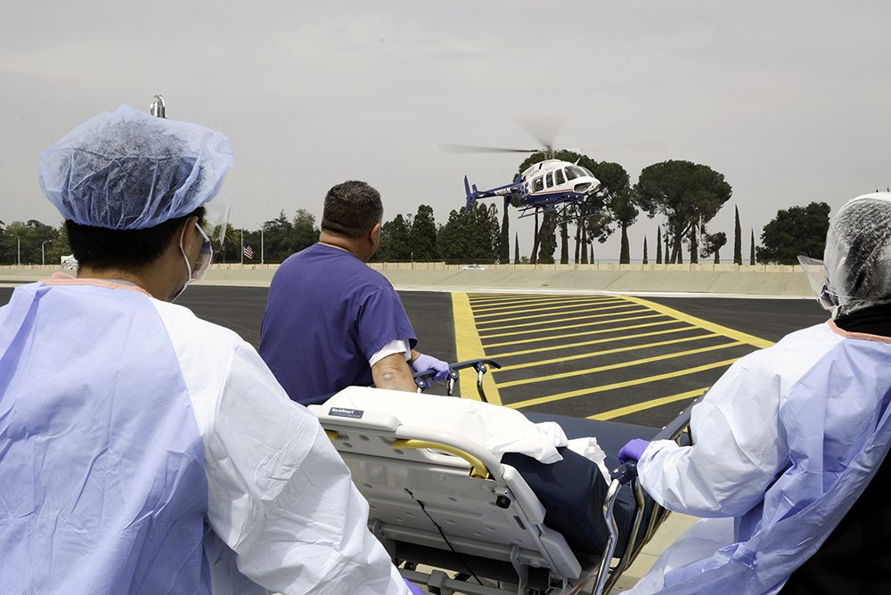 ARMC medical staff prepares to treat a patient arriving in a medical helicopter, illustrating the hospital’s Level I trauma care for critically ill and injured patients.
