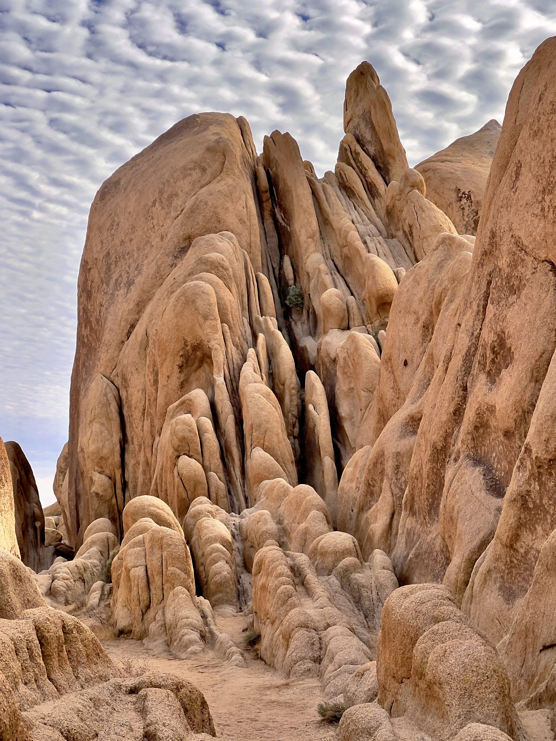 Large rock formations with a cloudy sky above.