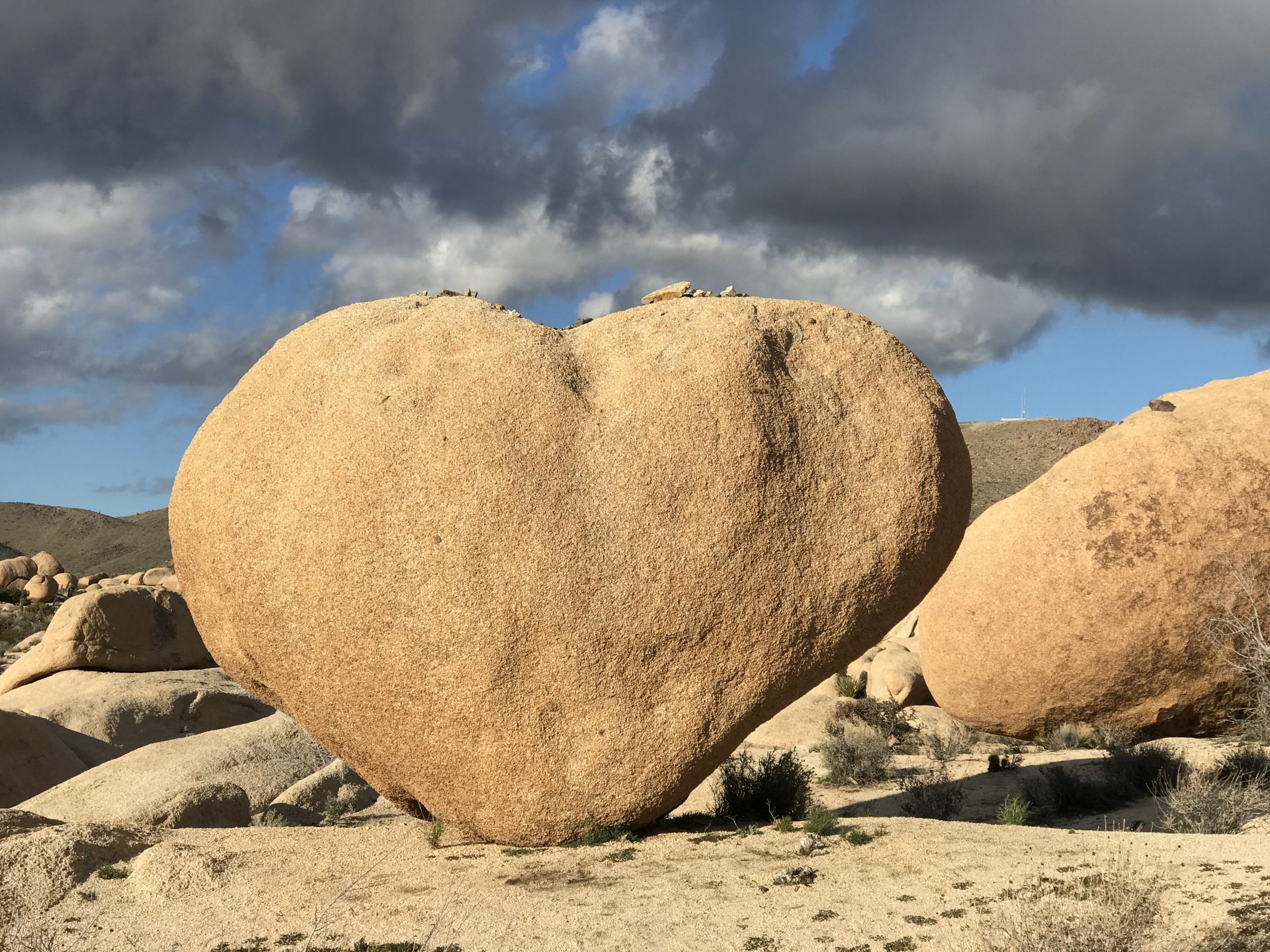 A heart shaped rock formation in a desert landscape.