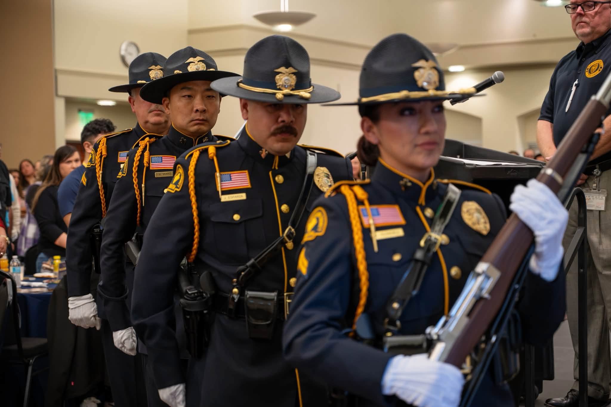 Probation Honor Guard members carry ceremonial rifles during the presentation of colors.