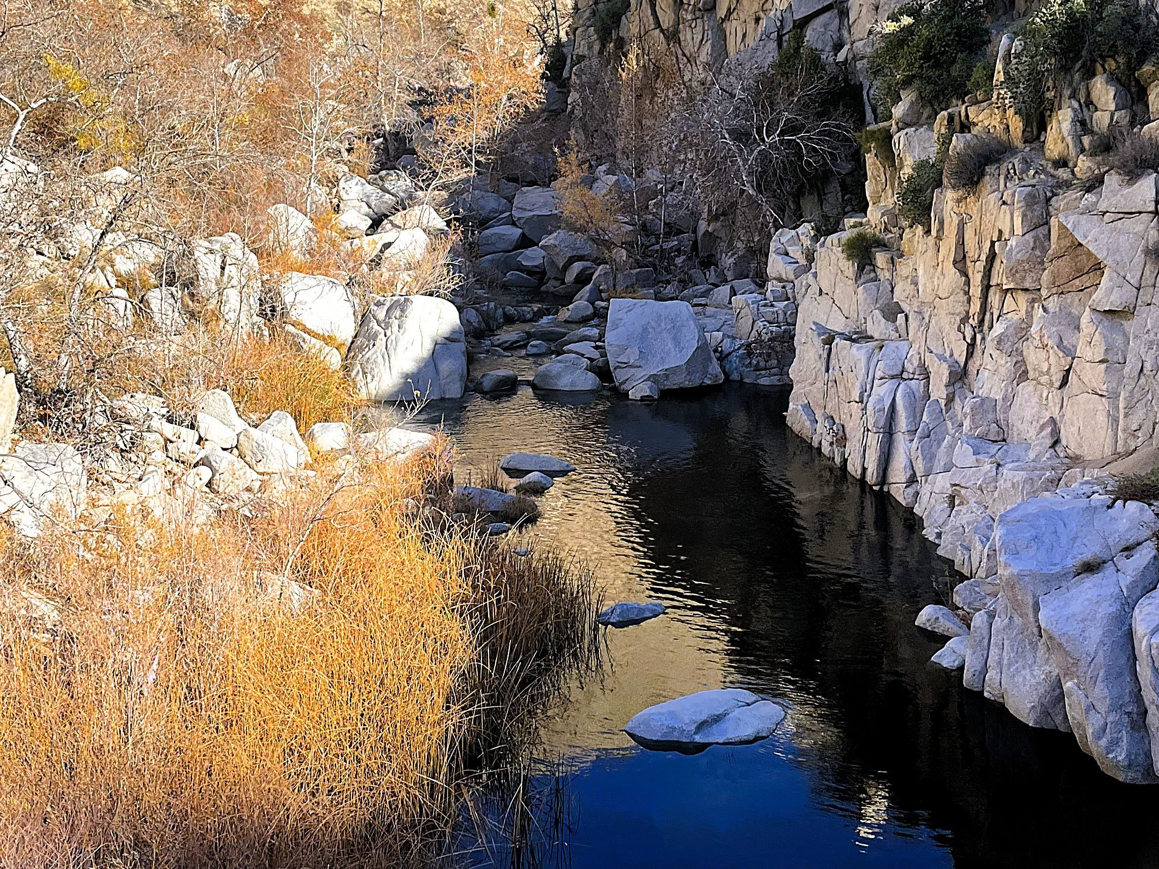 A creek surrounded by rocks and boulders.