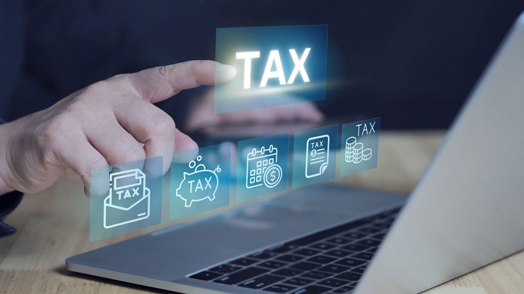 Businessman calculates taxes using laptop