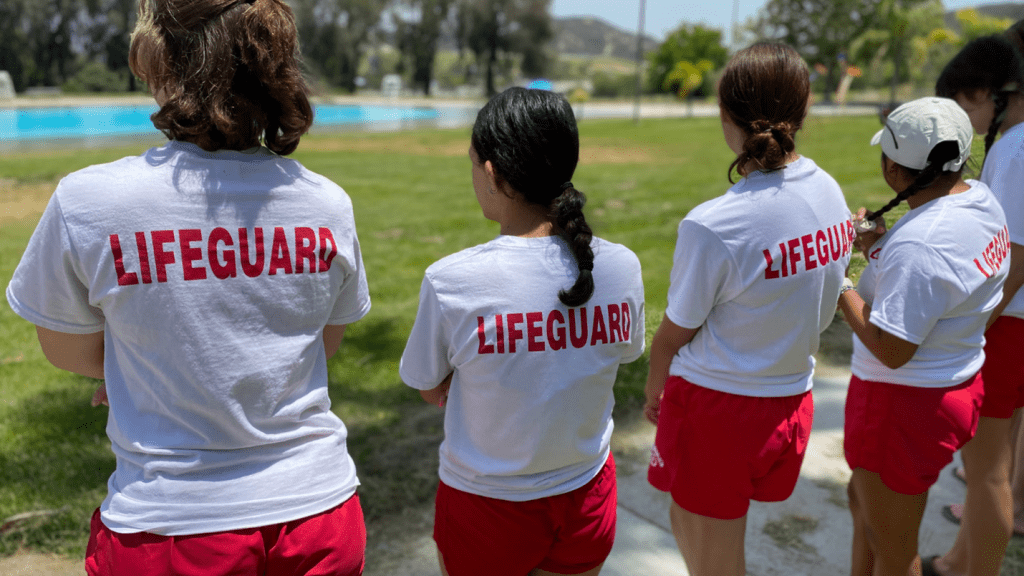 Female lifeguards prepare to perform training exercises during a lifeguard orientation event at Glen Helen Regional Park’s swim complex.