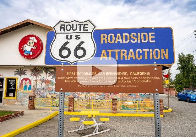 Route 66 Roadside Attraction sign at the site of the first McDonald's in San Bernardino. The sign includes historical information about McDonald's hamburgers and fries.