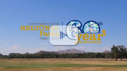 San Bernardino County Regional Parks 60th Anniversary logo over scenic park landscape with mountains and blue sky.