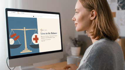 Woman working at a computer displaying the Lives in the Balance opioid data StoryMap.