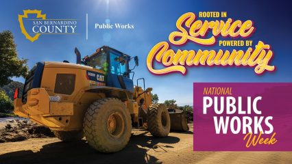 Public Works loader under bright blue sky with “Rooted in Service, Powered by Community” National Public Works Week text.