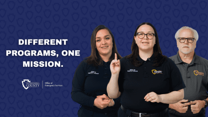 Three Office of Emergency Services team members stand together with the message: “Different Programs, One Mission.”