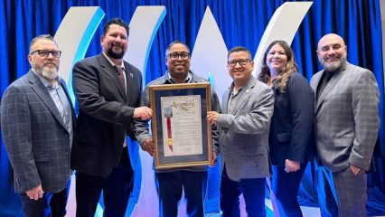Michael Stoffel, Leonardo Gonzalez, Jeff Gonzalez, Jesse Armendarez, Gina King, and Jose Mancilla stand together holding a framed California State Assembly resolution at CSAC award ceremony.